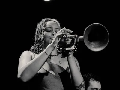 Feven Playing trumpet in a black and white image